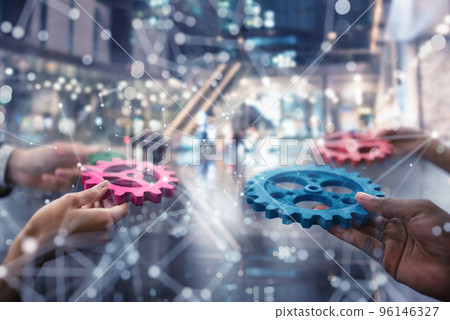 Business team connect pieces of gears. Teamwork, partnership and integration concept. double exposure Business team connect pieces of gears. Teamwork, partnership and integration concept. double exposure 96146327