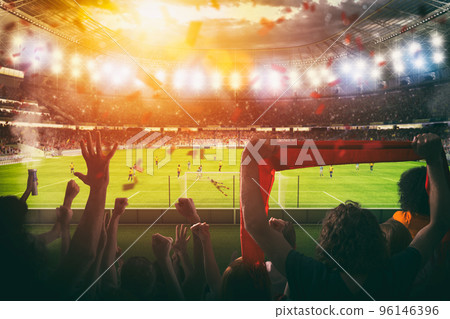Football scene at night match with with cheering fans at the stadium 96146396
