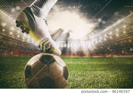 Close up of a soccer striker ready to kicks the ball at the stadium Close up of a soccer striker ready to kicks the ball at the stadium 96146397