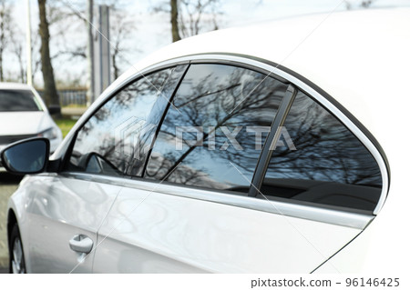 Modern car with tinting foil on window outdoors, closeup 96146425