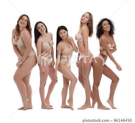 Group of women with different body types in jeans and underwear taking selfie against light 96146450