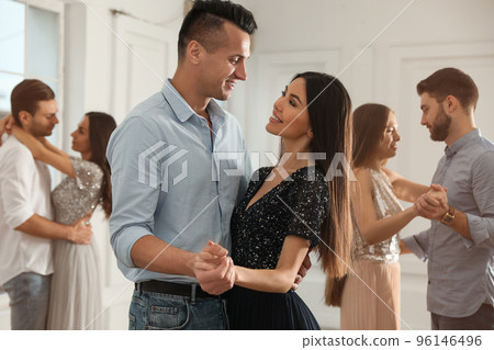 Lovely young couple dancing together at party 96146496