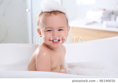 Cute little baby in bathtub at home 96146656