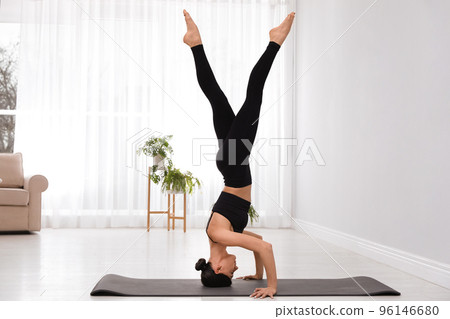 Professional young acrobat practicing yoga at home 96146680
