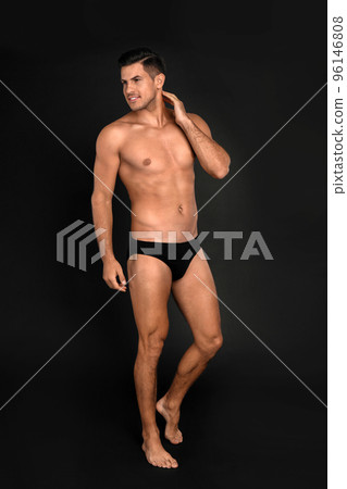 Handsome man in underwear on black background 96146808