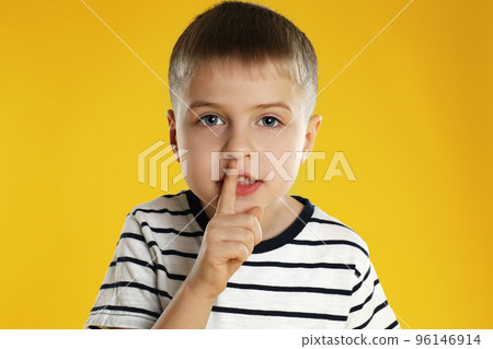 Portrait of little boy on yellow background Portrait of little boy on yellow background 96146914