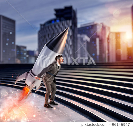 Determination and power businessman that holds a rocket. Startup concept Determination and power businessman that holds a rocket. Startup concept 96146947