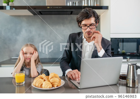 Annoyed daughter with her father that works with a laptop 96146983