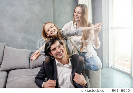 Happy little girl play with her mother and father Happy little girl play with her mother and father 96146990