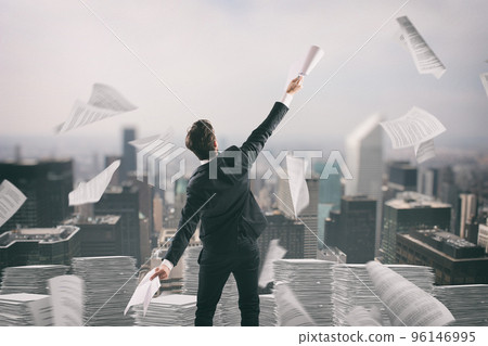Businessman tired of bureaucracy throws up sheets of paper in the air 96146995