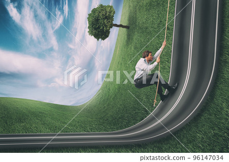 Businessman climbs a road bent upwards. Achievement business goal and difficult career concept 96147034