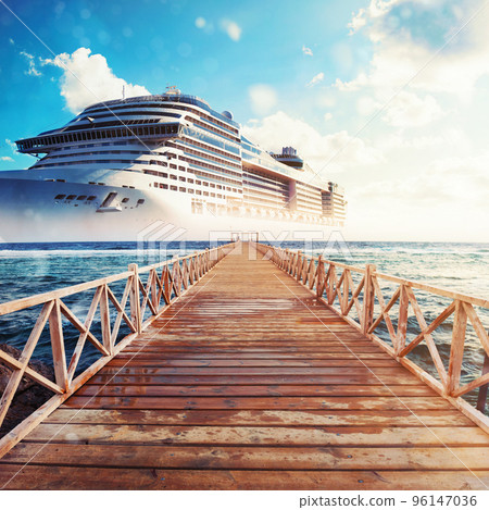 Jetty leading to the cruise ship ready to sail for a trip Jetty leading to the cruise ship ready to sail for a trip 96147036