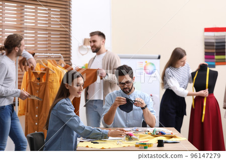 Fashion designers creating new clothes in studio 96147279