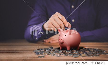 Man putting coin into piggy bank for saving money concept, business finance and investment. 96148352