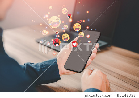 Man using a mobile phone with social media. Concept of living on vacation and playing social media on smartphone, social media and digital online and free time. Man using a mobile phone with social media. Concept of living on vacation and playing social media on smartphone, social media and digital online and free time. 96148355