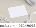 Greeting card or invitation card mockup with beige dry flower leaves on beige background, top view mock-up for design 96149095
