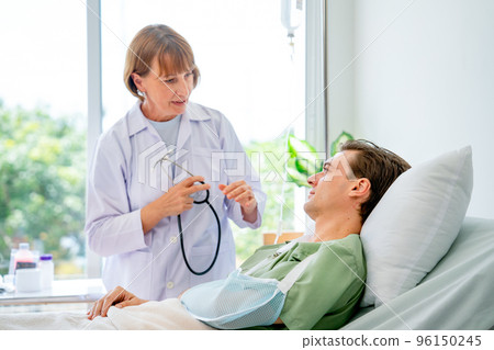 Caucasian woman doctor talk and discuss with young patient man who have arm problem Caucasian woman doctor talk and discuss with young patient man who have arm problem 96150245