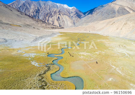 Landscape aerial view of mountains with river and green valley in Himalayas with blue sky in Nubra valley, Jammu and Kashmir, India. Landscape aerial view of mountains with river and green valley in Himalayas with blue sky in Nubra valley, Jammu and Kashmir, India. 96150696