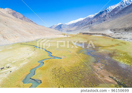 Landscape aerial view of mountains with river and green valley in Himalayas with blue sky in Nubra valley, Jammu and Kashmir, India. Landscape aerial view of mountains with river and green valley in Himalayas with blue sky in Nubra valley, Jammu and Kashmir, India. 96150699