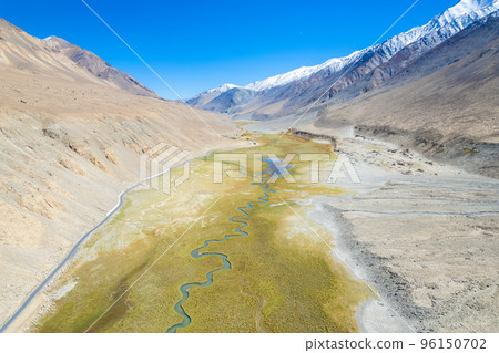 Landscape aerial view of mountains with river and green valley in Himalayas with blue sky in Nubra valley, Jammu and Kashmir, India. Landscape aerial view of mountains with river and green valley in Himalayas with blue sky in Nubra valley, Jammu and Kashmir, India. 96150702