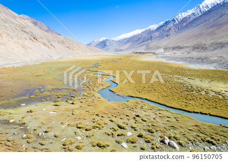 Landscape aerial view of mountains with river and green valley in Himalayas with blue sky in Nubra valley, Jammu and Kashmir, India. Landscape aerial view of mountains with river and green valley in Himalayas with blue sky in Nubra valley, Jammu and Kashmir, India. 96150705