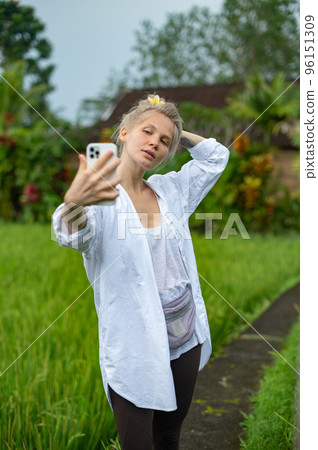 Girl make a selfie outdoor in green rice terrace 96151309