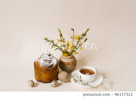 Easter composition with kulich and eggs with spring flowers on beige background. Easter holidays breakfast concept. 96157322