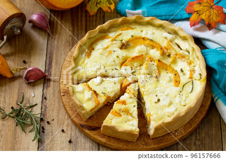 Classic Quiche Lorraine Pie with Pumpkin and Feta Cheese on a wooden table. Copy space. 96157666