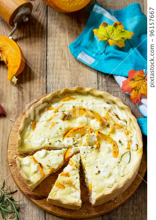 Classic Quiche Lorraine Pie with Pumpkin and Feta Cheese on a wooden table. Copy space. Classic Quiche Lorraine Pie with Pumpkin and Feta Cheese on a wooden table. Copy space. 96157667