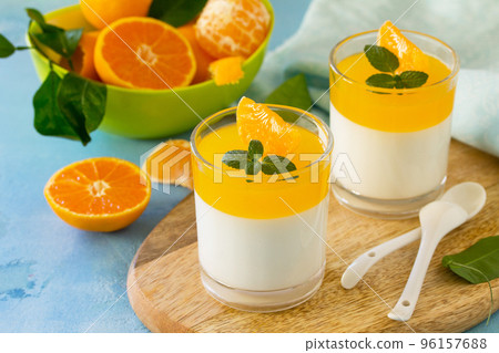 Panna cotta with tangerines jelly and mint, Italian dessert, homemade cuisine. 96157688