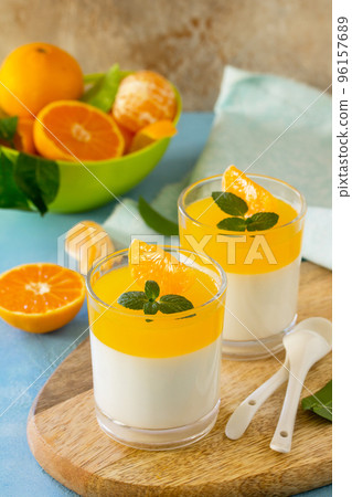 Panna cotta with tangerines jelly and mint, Italian dessert, homemade cuisine. 96157689