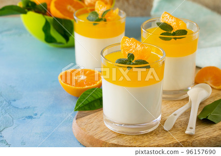 Panna cotta with tangerines jelly and mint, Italian dessert, homemade cuisine. Copy space. Panna cotta with tangerines jelly and mint, Italian dessert, homemade cuisine. Copy space. 96157690