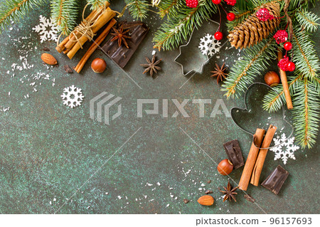Ingredients for Christmas Gingerbread baking - chocolate, cinnamon, anise and nuts on dark a stone or slate background. Seasonal, food background. Top view flat lay background. Copy space. 96157693