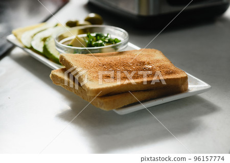 Two toast with sliced avocado, butter, cheese for a healthy sandwich. Two toast with sliced avocado, butter, cheese for a healthy sandwich. 96157774