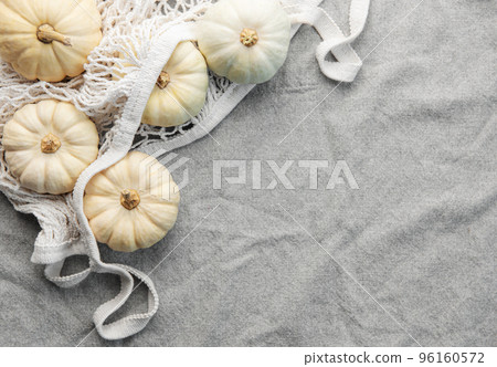 Top view autumn composition with pumpkins in mesh shopping bag Top view autumn composition with pumpkins in mesh shopping bag 96160572
