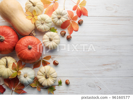 Autumn leaves and pumpkins over old wooden background Autumn leaves and pumpkins over old wooden background 96160577