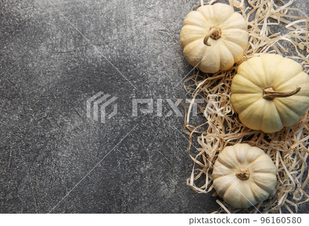Autumn leaves and pumpkins over  grey concrete background 96160580