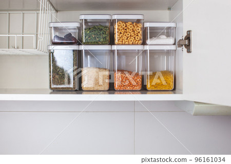 Storage ideas in the kitchen. White box and basket. Shelf order system.  96161034