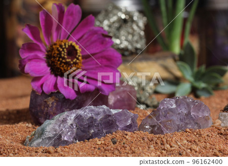 Chakra Stones and Flowers With Australian Red Sand on Meditation Table 96162400