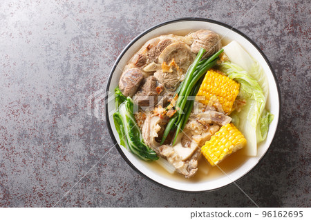 Bulalo is a Filipino stew made from beef shanks and marrow bones closeup in the bowl. Horizontal top view Bulalo is a Filipino stew made from beef shanks and marrow bones closeup in the bowl. Horizontal top view 96162695