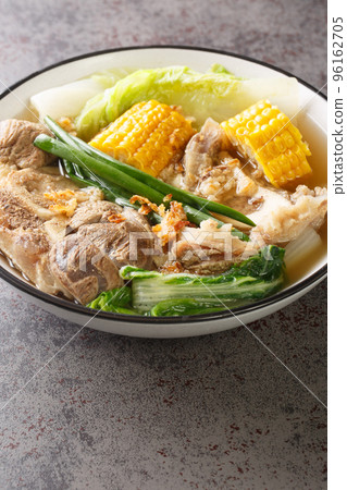 Filipino food Beef Bulalo or boiled beef shank soup closeup in the bowl. Vertical 96162705