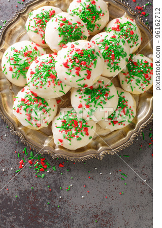 Italian Christmas Cookies are soft, buttery, fluffy with a hint of vanilla closeup in the plate. Vertical top view 96162712