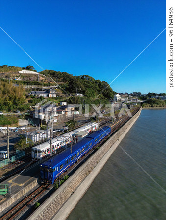 A local train running on the Nagasaki Main Line along the coast 96164936