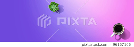 A cup of coffee and a small plant A cup of coffee and a small plant 96167166