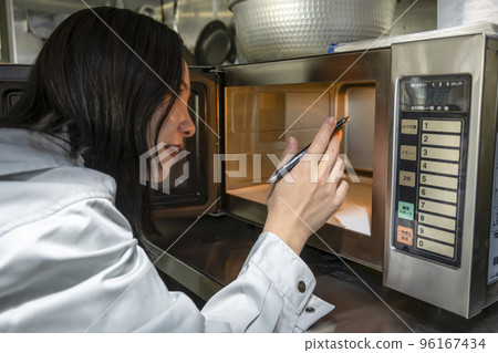 Young Beautiful Woman Using Microwave Oven Stock Photo 317199641