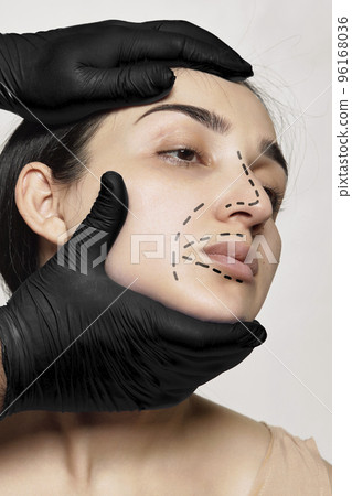 a woman's face with black gloves on her head and one hand in the shape of an arrow pointing upwards 96168036