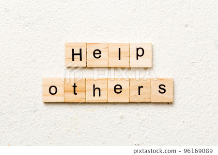 Help others word written on wood block. Help others text on table, concept Help others word written on wood block. Help others text on table, concept 96169089