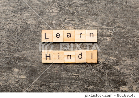 Learn Hindi word written on wood block. Learn Hindi text on table, concept Learn Hindi word written on wood block. Learn Hindi text on table, concept 96169145