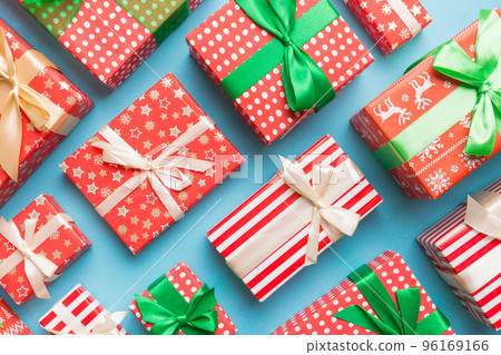 A lot of Christmas gift boxes in colored paper decorated on table, Top view close up. Many present New Year gift 96169166