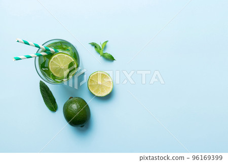 Caipirinha, Mojito cocktail, vodka or soda drink with lime, mint and straw on table background. Refreshing beverage with mint and lime in glass top view flat lay 96169399